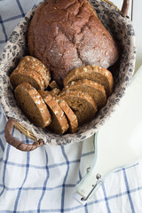 Wicker basket with bread and milk on a white background