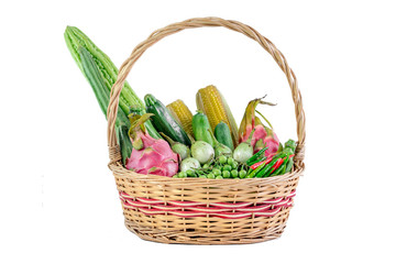 Vegetables and fruits in wicker basket isolated on white background.


