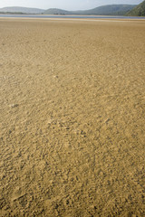 Textured sea sand by river mouth