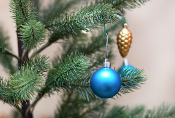 Fototapeta na wymiar Decorated Christmas tree, vivid blue sparkling ball,selective focus