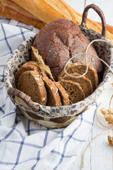 bread in a wicker basket and a baguette