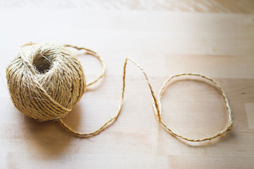 A top angle of a decorative hemp rope on wooden table