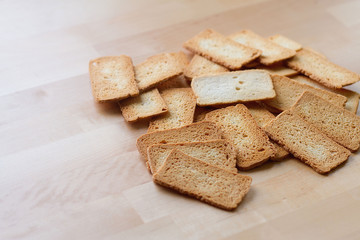 A top angle of crackers on wooden table, a sort of biscuit , brown cracker made from flour