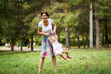 Fototapeta premium Small cute baby and nice mom outdoors