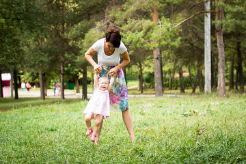 Small cute baby and nice mom outdoors