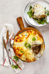 Vegetable Lasagna on a stone table with arugula