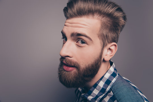 Closeup portrait of funny glad hipster bearded man looking at ca