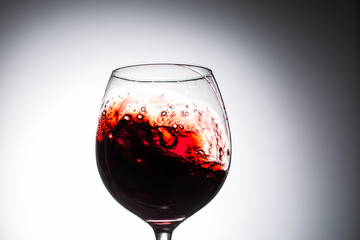 Stream of wine being pouring into a glass.