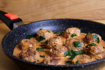 Meatballs and sauce, an excellent dinner, homemade food on a wooden table