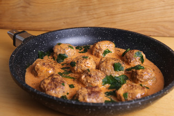 Meatballs and sauce, an excellent dinner, homemade food on a wooden table