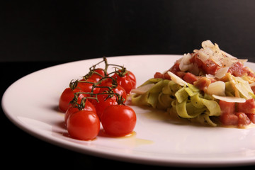 Fettuccine cream sauce with ham, Parmesan cheese, roasted cherry tomatoes, bio vegetables, rustic food, homemade food, home made basil pasta 