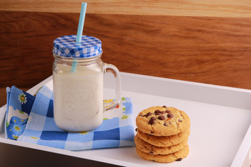 Milk in a Kilner with Cookies on a white tray
