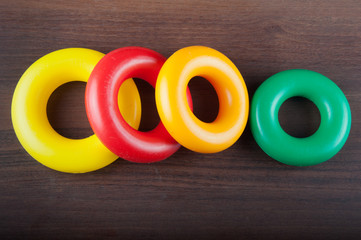 Range of multicolored plastic rings on dark background