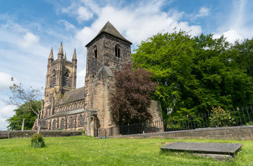 Fototapeta na wymiar The Old tower built in the 13th Century still standing in front of the present St Mary's Church in Mirfield, West Yorkshire, England.