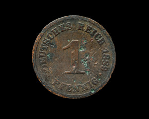 Very old german copper coin isolated on black