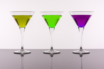 Colorful Cocktails in Martini Glasses Background. Bar Commercials Concept.