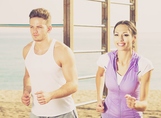 Young couple running on beach