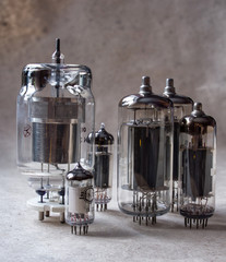 vertical composition of different radio lamps on kraft paper. vintage electronic background.