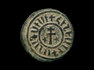 Ancient copper armenian coin with cross isolated on black