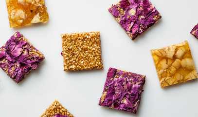 Flat lay composition with oriental sweets square shape on a white background