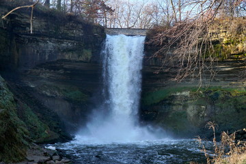 Minnehaha Falls in Minneapolis Minnesota off of the Mississippi River in a beautiful recreation park. Waterfall freezes over in cold winter weather months.
