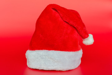 Obraz na płótnie Canvas Santa Claus hat on red background