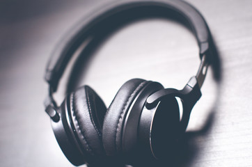 Headphones on a dark background. Music accessories. Bluetooth headphones without cable. 