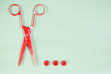 Pop art. Scissors and buttons on close up on wooden board