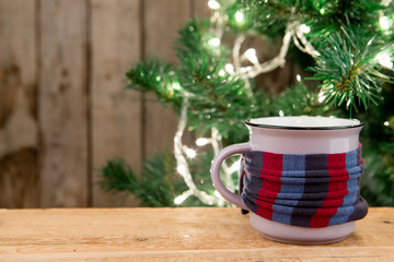 Ginger tea in a cup on wooden background