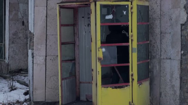 Man in abandoned telephone booth