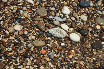 Close up of a pebble beach with the sea.