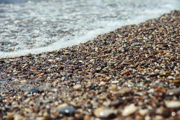 Close up of a pebble beach with the sea.
