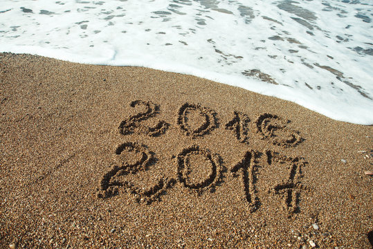 Numbers 2017 on beach. New year holiday concept .