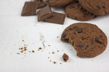 Chocolate biscuits with milk chocolate on white wood