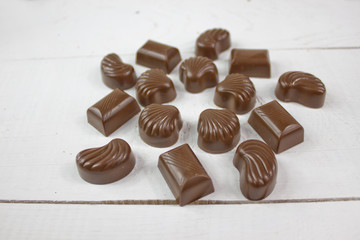 Chocolate candy with on white wood