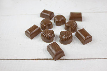 Chocolate candy with on white wood