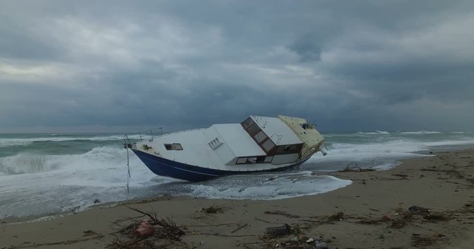 Barca degli immigrati arenata sulla costa dopo una forte tempesta in mare. 