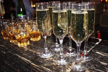 full glasses on a wooden stand © elenahell