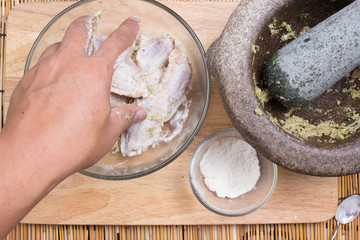 Chef mixing flour to chicken wings for cooking