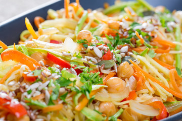 close up of fresh veggie pasta on a black plate