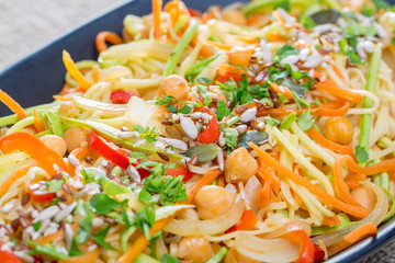 close up of fresh veggie pasta on a black plate