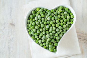 frozem peas on wooden surface