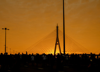 Elevated expressway / Silhouette of elevated expressway and crowd of people cross the river at...
