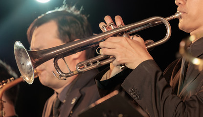 Jazz / View of bugler blowing the trumpet in concert at night. Movement.