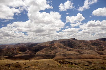 Beautiful sky over the wavy deforested landscape of northwest Madagascar