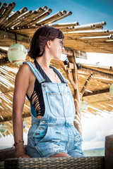 Close-up portrait of smiling female in the outdoor wooden bar near the Indian ocean, tropical island Bali, Indonesia, Asia.