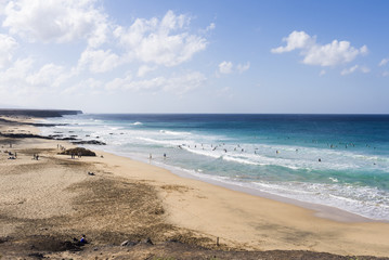 Surfer at Playa Moro, Corralejo, Fuerteventura a popular beach b