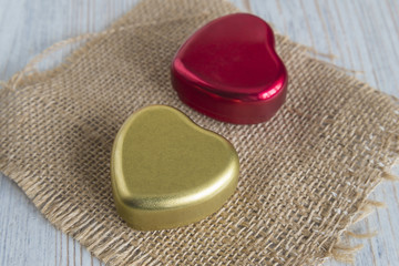 valentine concept/two boxes shaped hearts on sackcloth background