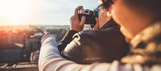 Couple taking pictures on the rooftop