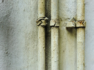 Urban ghetto pipe plumbing against grungy wall texture